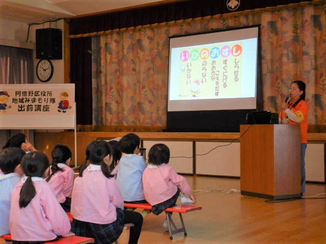 スクリーンに映写した防犯標語いかのおすしを学ぶ園児たち
