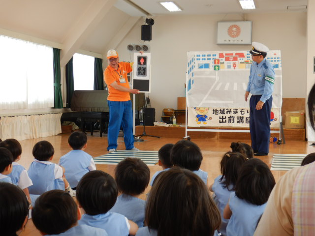 歩行者信号の模型を使って信号の色をたずねる区役所職員