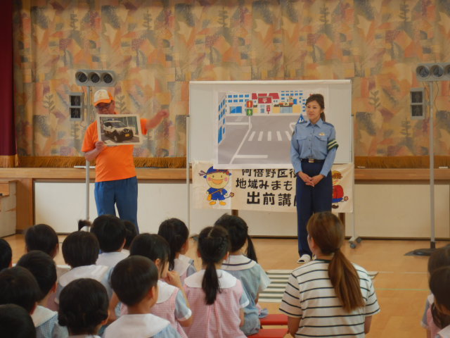 園児に青パトの写真を見せて自己紹介をする区役所職員