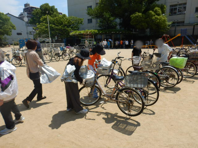 キャンペーン参加者の自転車前かごにひったくり防止カバーを取りつける