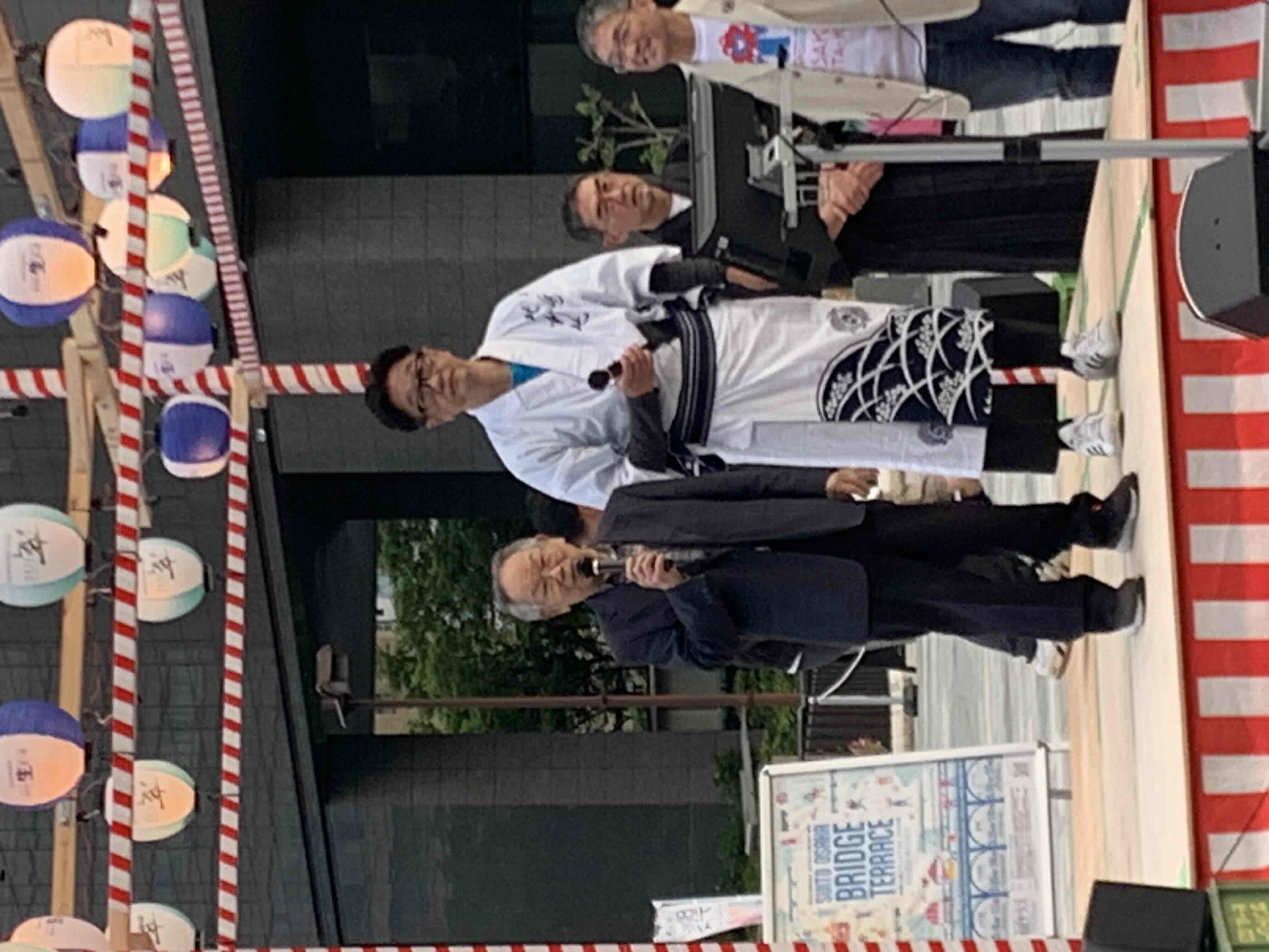 登壇する元堂島地域連合振興町会長の山本弘澄さん