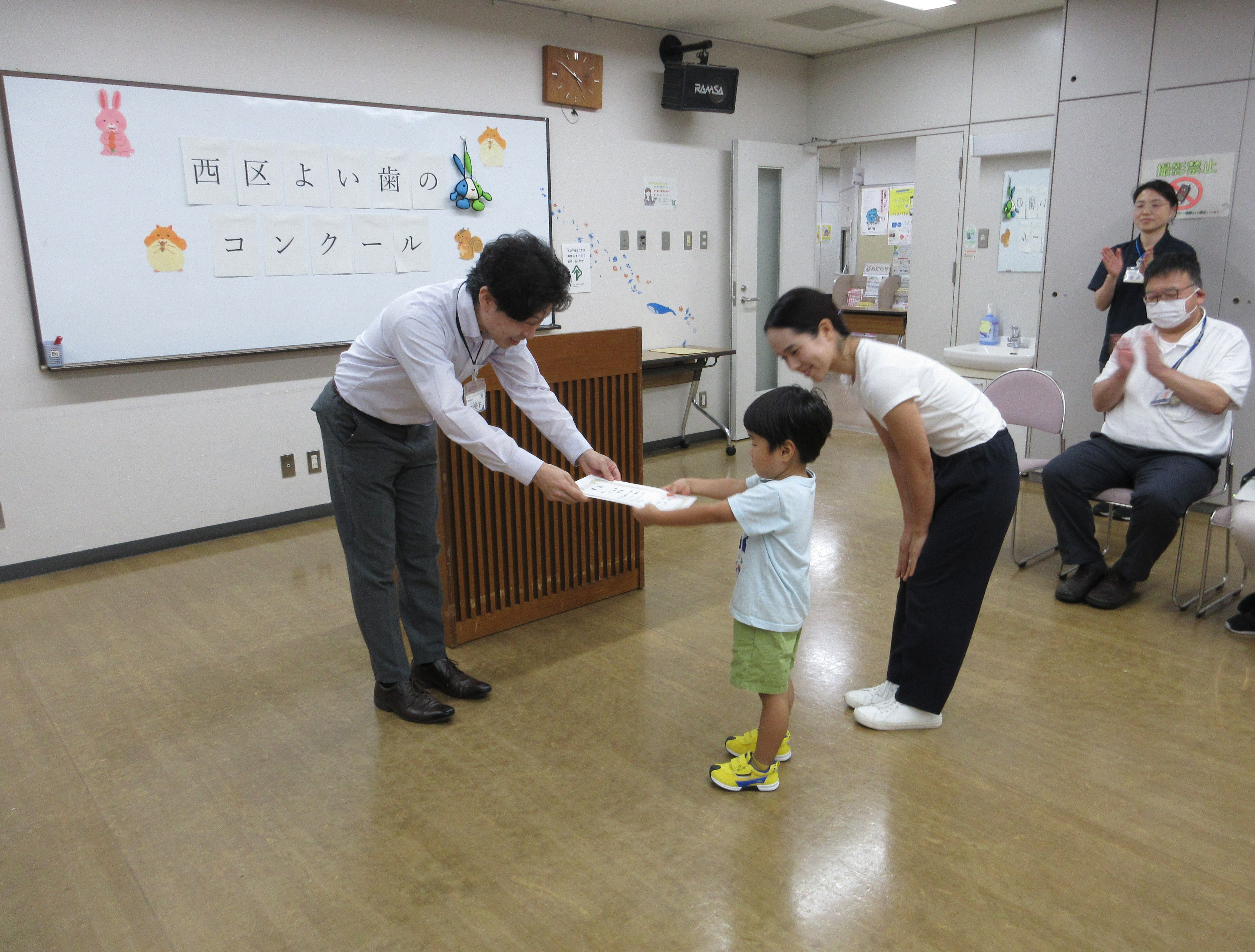 表彰状を受け取る親子の写真
