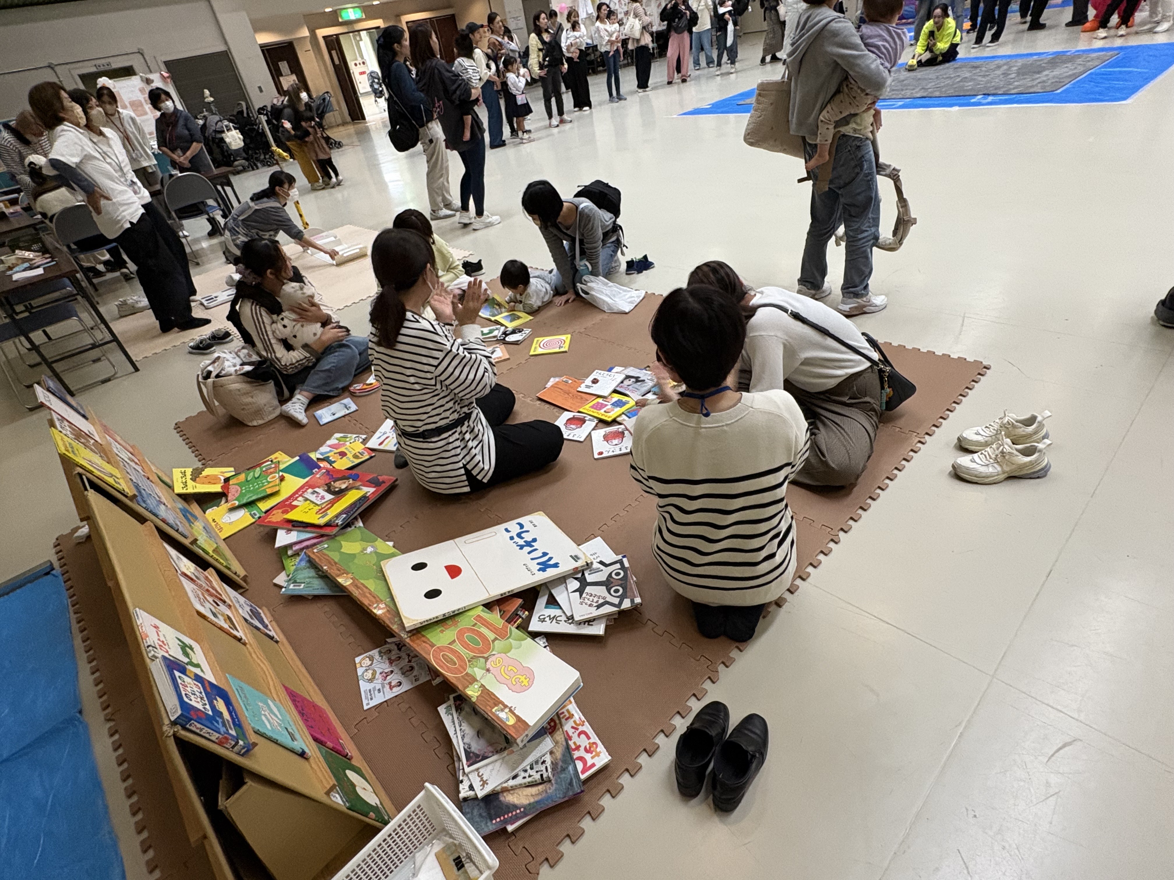 絵本コーナーで絵本を見ている親子