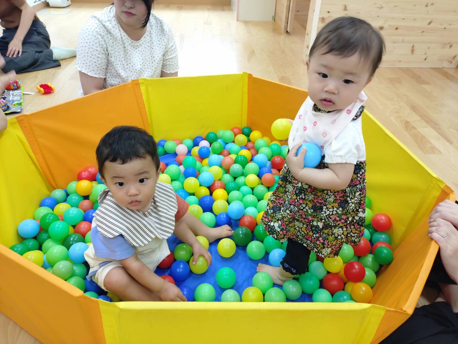 ボールプールに入って遊んでいる2人の子ども